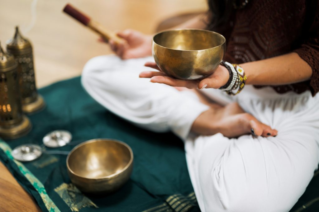 woman holding tool for sound bath